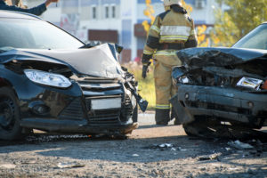 Florida fireman rescuing car accident victims on a road in Spring Hill, FL.