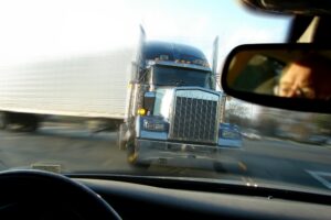 Commercial truck making a turn in the highway.