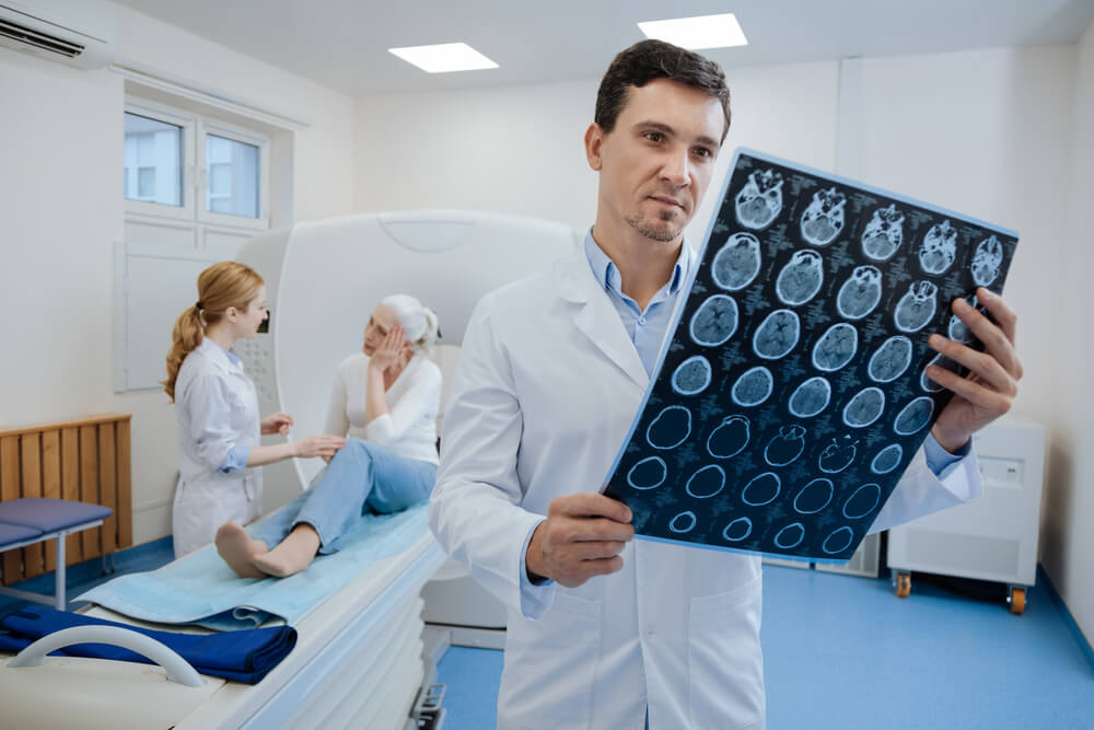 Doctor reading brain ct-scan of patient.