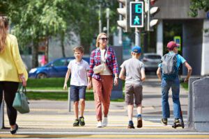 Mother and son crossing street on walk signal.