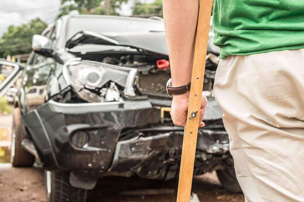 Passenger injured from car accident with crutches.