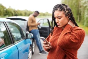 Lady driver feeling hurt after the car accident.